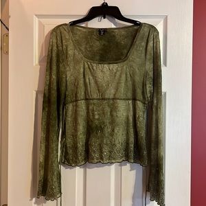 green low cut shirt. flare arms with sparkles and a tie around. super cute on!